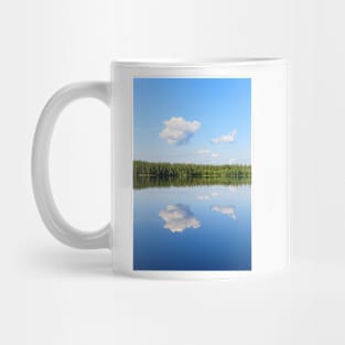 Sky reflects from still lake at summer day Mug